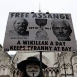 A demonstrator holds a placard in support of Julian Assange outside the Royal Courts of Justice in London, Britain, February 21, 2024